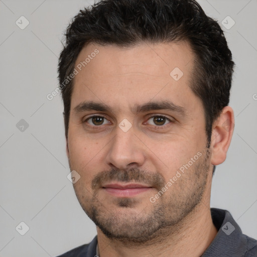 Joyful white young-adult male with short  black hair and brown eyes