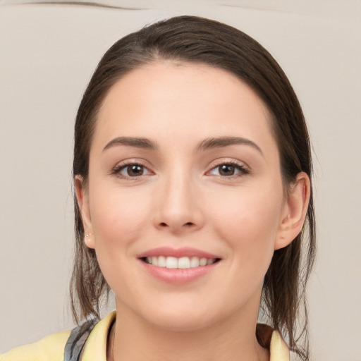 Joyful white young-adult female with medium  brown hair and brown eyes