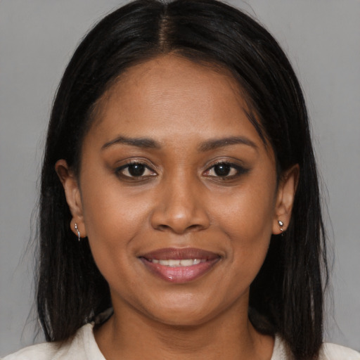 Joyful black young-adult female with medium  brown hair and brown eyes