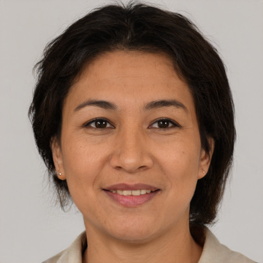 Joyful asian adult female with short  brown hair and brown eyes