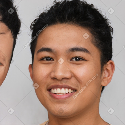 Joyful latino young-adult male with short  brown hair and brown eyes