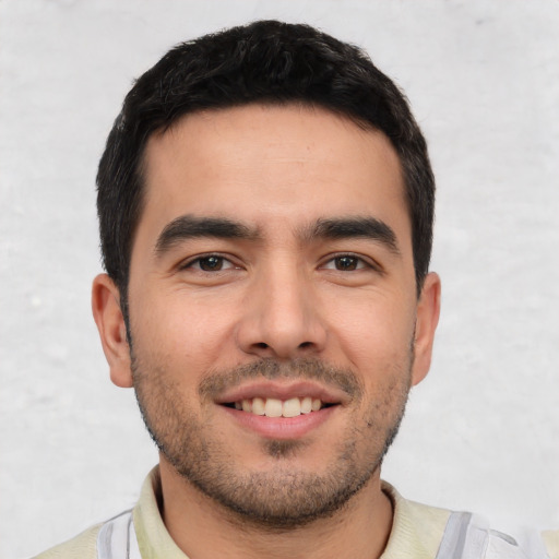 Joyful white young-adult male with short  black hair and brown eyes