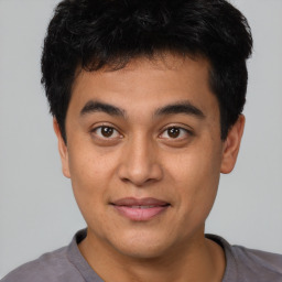 Joyful asian young-adult male with short  black hair and brown eyes