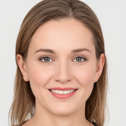 Joyful white young-adult female with long  brown hair and grey eyes