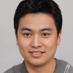 Joyful asian young-adult male with short  black hair and brown eyes