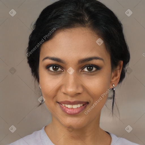 Joyful black young-adult female with medium  black hair and brown eyes