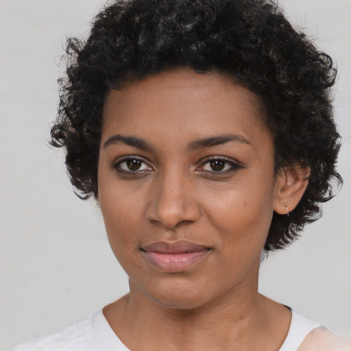 Joyful black young-adult female with short  black hair and brown eyes