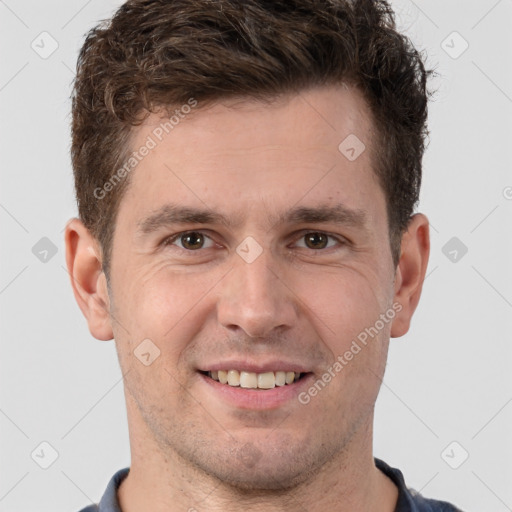 Joyful white adult male with short  brown hair and grey eyes