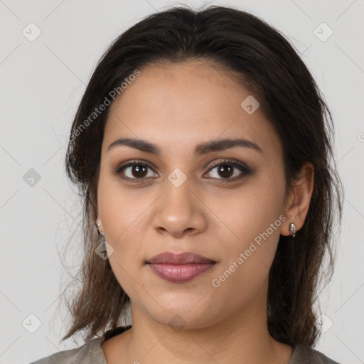 Joyful latino young-adult female with medium  brown hair and brown eyes