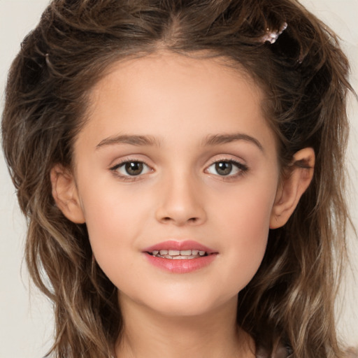 Joyful white child female with long  brown hair and brown eyes