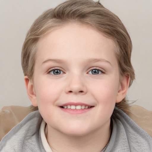 Joyful white child female with short  brown hair and blue eyes