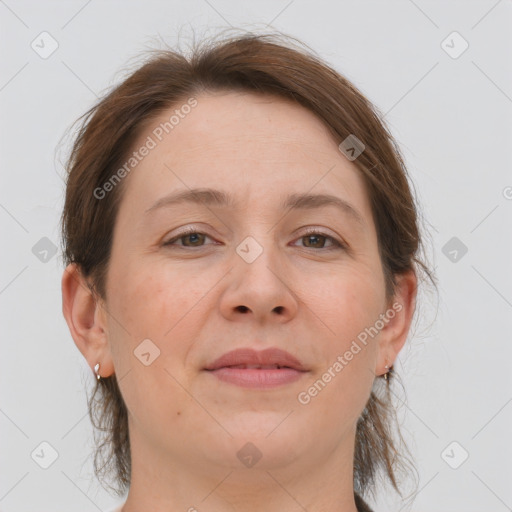 Joyful white adult female with medium  brown hair and grey eyes