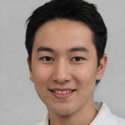 Joyful asian young-adult male with short  black hair and brown eyes