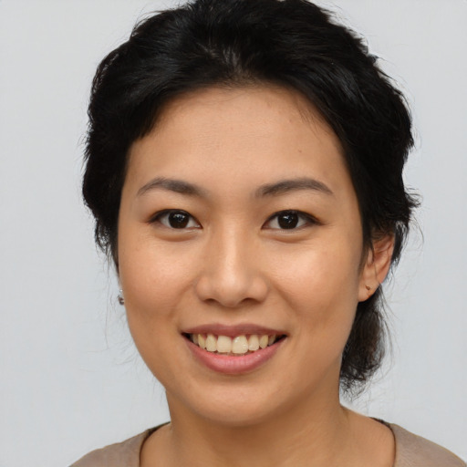 Joyful asian young-adult female with medium  brown hair and brown eyes