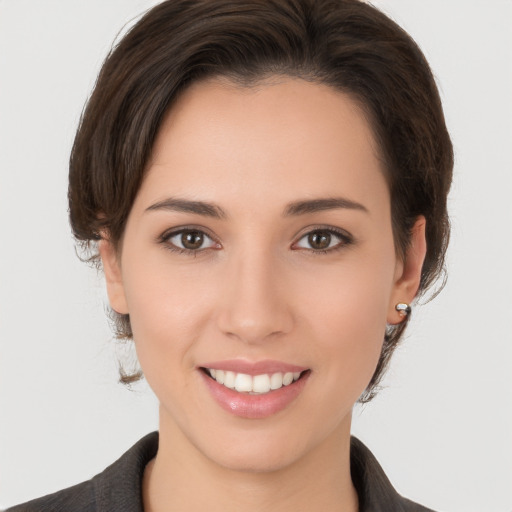 Joyful white young-adult female with medium  brown hair and brown eyes