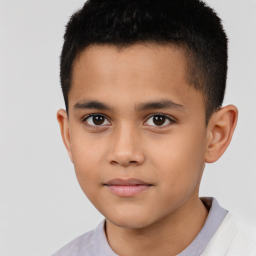 Joyful latino child male with short  brown hair and brown eyes