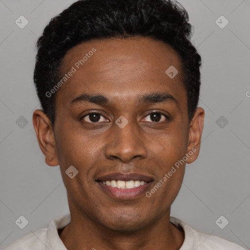 Joyful black young-adult male with short  black hair and brown eyes