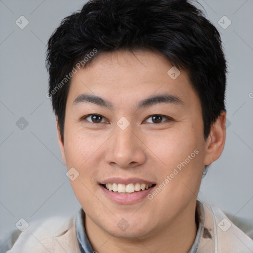 Joyful asian young-adult male with short  brown hair and brown eyes