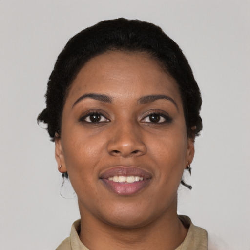 Joyful black young-adult female with short  black hair and brown eyes