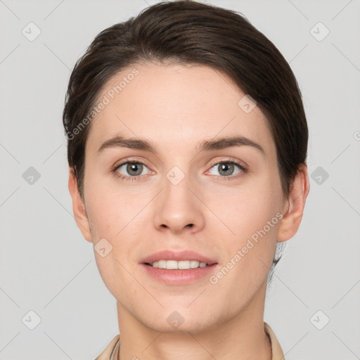 Joyful white young-adult female with short  brown hair and grey eyes