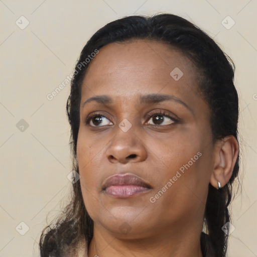 Joyful black young-adult female with long  black hair and brown eyes