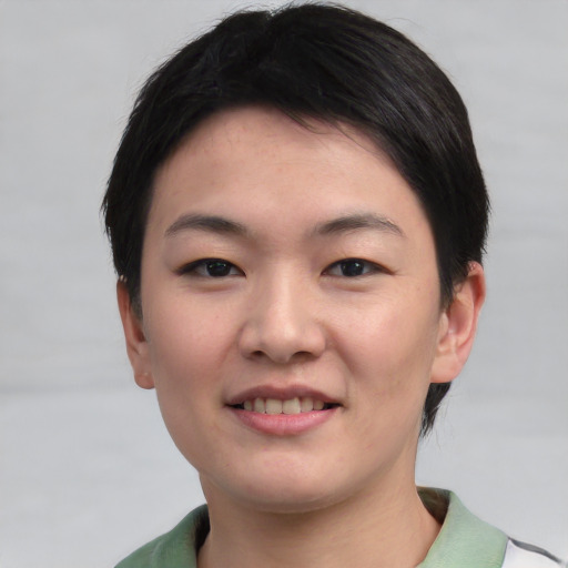 Joyful asian young-adult female with short  black hair and brown eyes