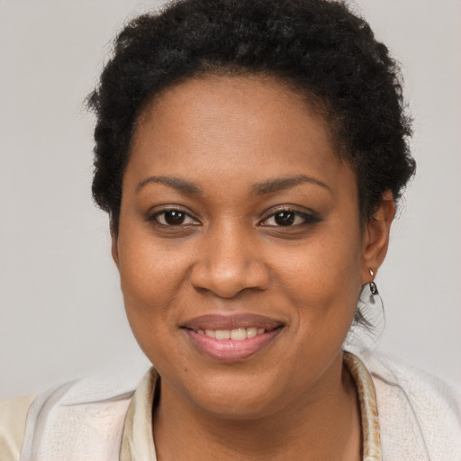 Joyful black young-adult female with short  brown hair and brown eyes