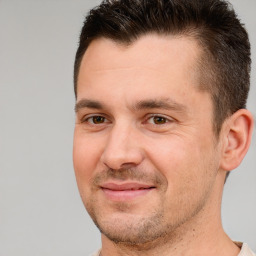 Joyful white adult male with short  brown hair and brown eyes