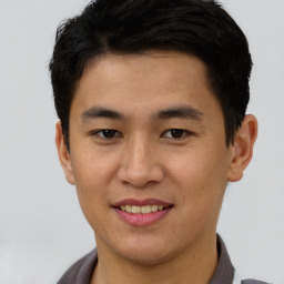 Joyful asian young-adult male with short  brown hair and brown eyes