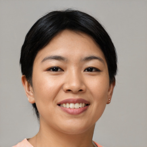 Joyful asian young-adult female with short  black hair and brown eyes