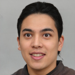 Joyful asian young-adult male with short  brown hair and brown eyes