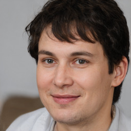 Joyful white adult male with medium  brown hair and brown eyes