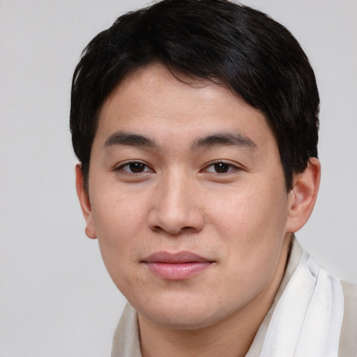 Joyful asian young-adult male with short  brown hair and brown eyes