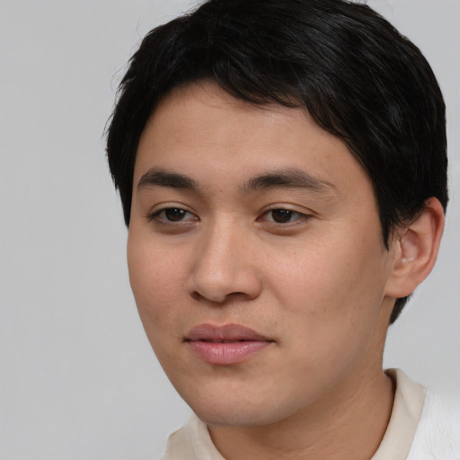 Joyful asian young-adult male with short  brown hair and brown eyes