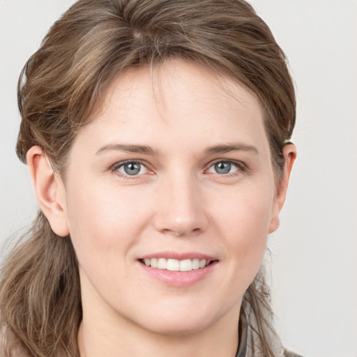 Joyful white young-adult female with long  brown hair and grey eyes