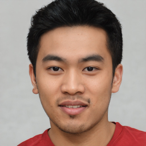 Joyful asian young-adult male with short  black hair and brown eyes