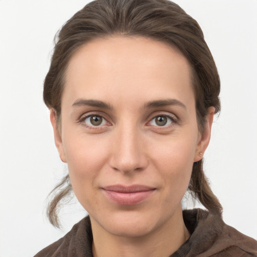 Joyful white young-adult female with medium  brown hair and grey eyes