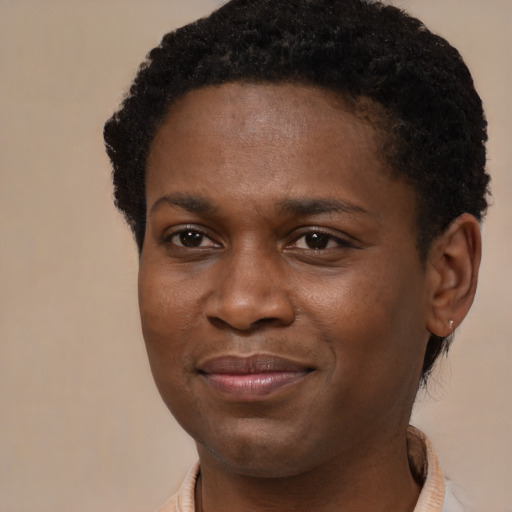 Joyful black young-adult male with short  brown hair and brown eyes