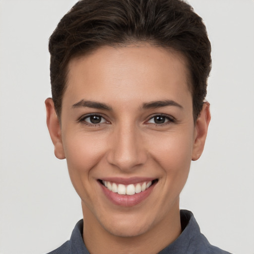 Joyful white young-adult female with short  brown hair and brown eyes