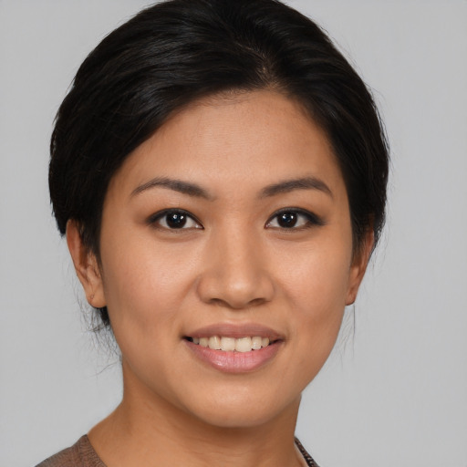Joyful asian young-adult female with medium  brown hair and brown eyes