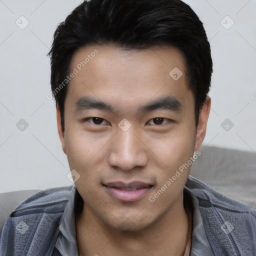 Joyful asian young-adult male with short  black hair and brown eyes