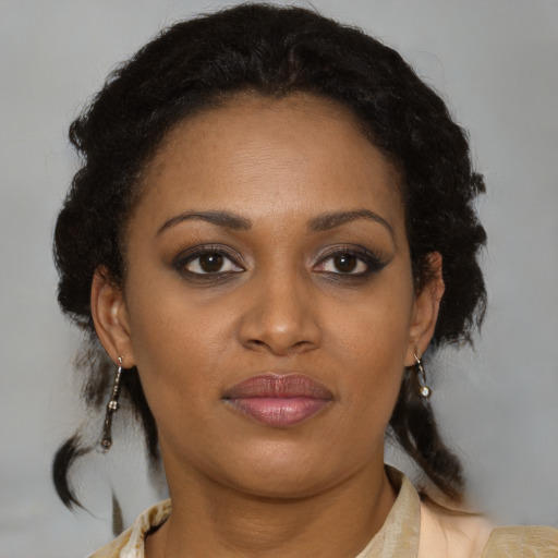 Joyful black young-adult female with medium  brown hair and brown eyes