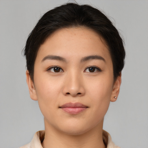 Joyful asian young-adult female with short  brown hair and brown eyes