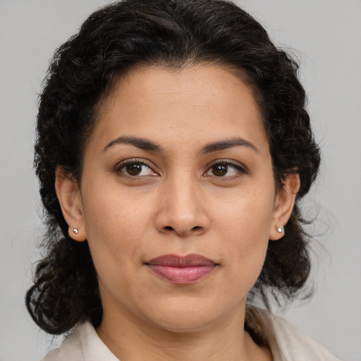 Joyful latino young-adult female with medium  brown hair and brown eyes