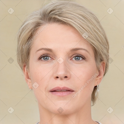 Joyful white adult female with medium  brown hair and grey eyes