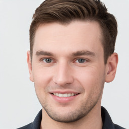 Joyful white young-adult male with short  brown hair and grey eyes