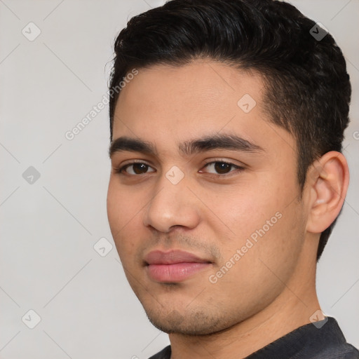 Joyful white young-adult male with short  black hair and brown eyes