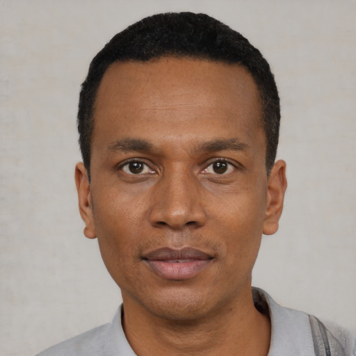 Neutral black young-adult male with short  black hair and brown eyes