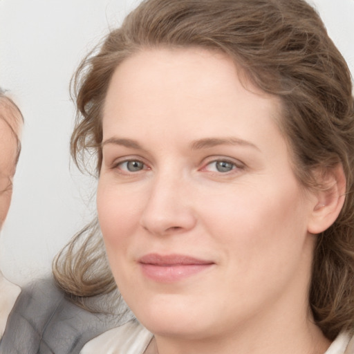 Joyful white young-adult female with medium  brown hair and blue eyes