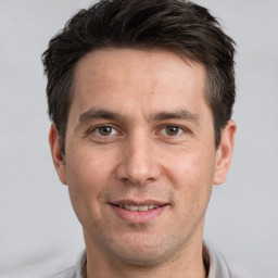 Joyful white adult male with short  brown hair and brown eyes